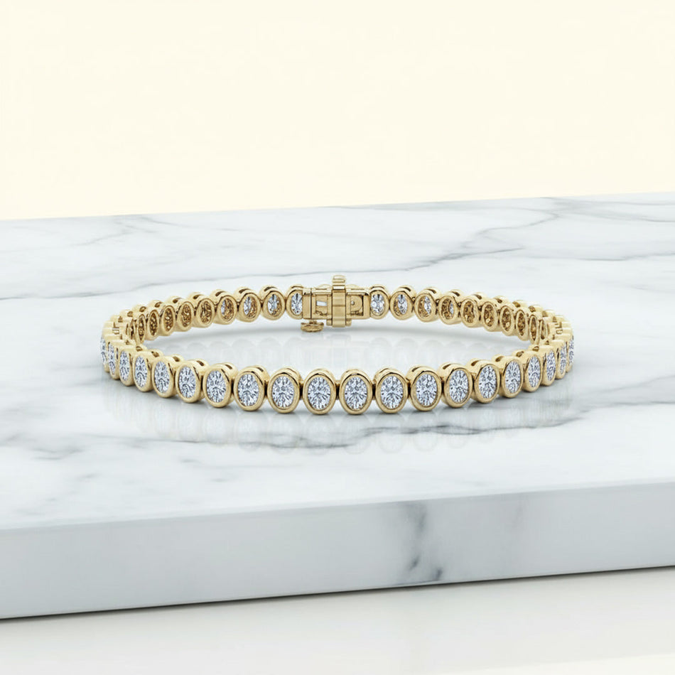 14.00 ctw Bezel-Set Lab Created Oval Sapphire Tennis Bracelet in 14K Yellow Gold Overlay