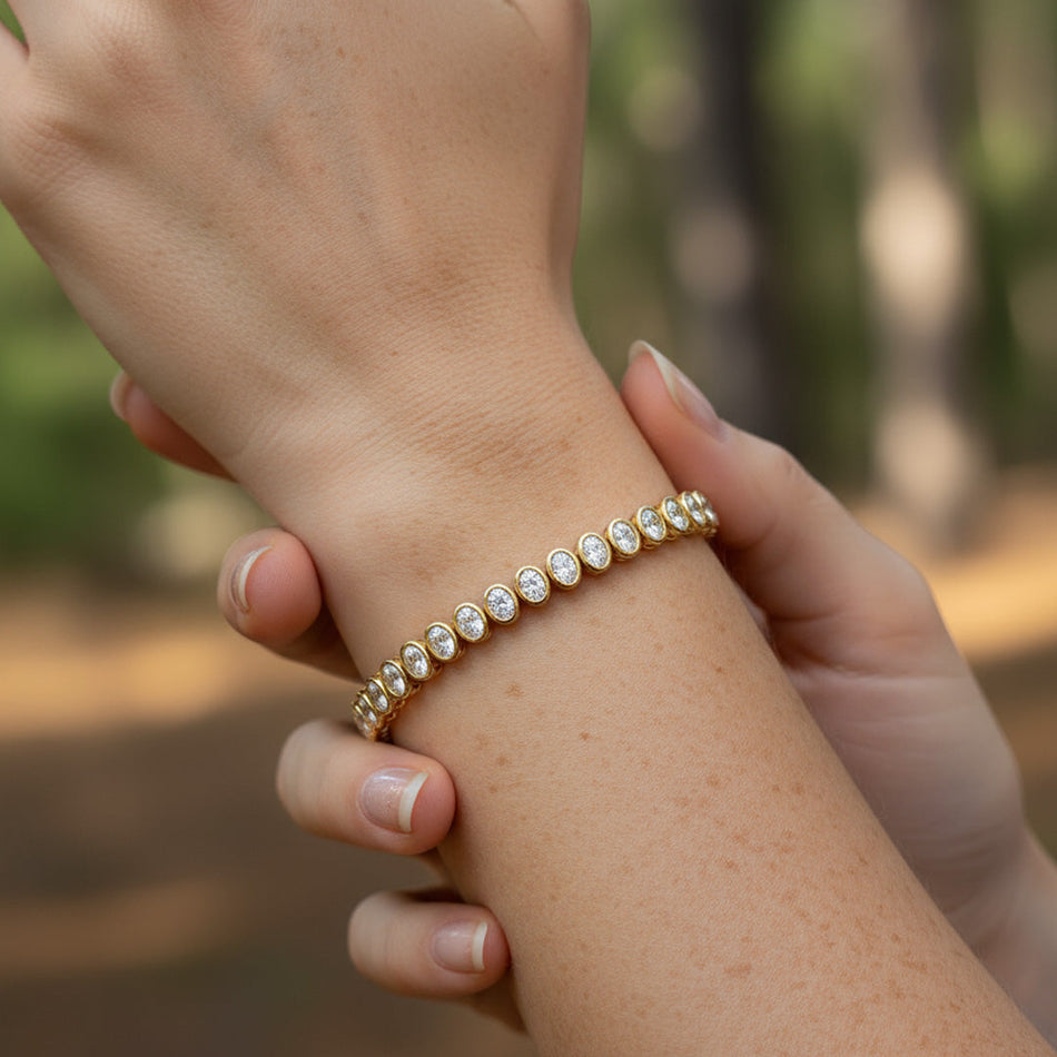 14.00 ctw Bezel-Set Lab Created Oval Sapphire Tennis Bracelet in 14K Yellow Gold Overlay